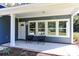 Inviting covered front porch with seating, offering a welcoming entrance to the home at 155 Mckenzie Circle, Pawleys Island, SC 29585