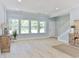 Sun-filled living room boasts hardwood floors, neutral paint, and a view of the staircase at 155 Mckenzie Circle, Pawleys Island, SC 29585