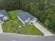 Overhead view of a home featuring a green lawn, a fence, and palm trees at 1600 Palmetto Palm Dr., Myrtle Beach, SC 29579