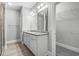 Bathroom featuring a dual sink vanity, a walk-in shower, and a walk-in closet at 1600 Palmetto Palm Dr., Myrtle Beach, SC 29579