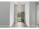 Bright foyer featuring an open front door, wood floors, neutral paint and stylish hanging light fixture at 1600 Palmetto Palm Dr., Myrtle Beach, SC 29579