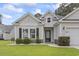 Inviting home featuring manicured lawn, black shutters, and attached garage at 1600 Palmetto Palm Dr., Myrtle Beach, SC 29579