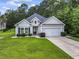 Beautiful home with light siding, a two-car garage, and well-kept landscaping at 1600 Palmetto Palm Dr., Myrtle Beach, SC 29579