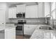 Close up of the kitchen with stainless steel appliances, granite counters and modern white cabinets at 1600 Palmetto Palm Dr., Myrtle Beach, SC 29579