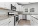 Well-lit kitchen with granite countertops, stainless steel appliances, and hardwood floors at 1600 Palmetto Palm Dr., Myrtle Beach, SC 29579