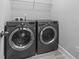 Laundry room with a gray washer and dryer set and overhead shelving at 1600 Palmetto Palm Dr., Myrtle Beach, SC 29579
