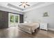 Bedroom with hardwood floors and sliding barn doors that lead to the backyard at 1600 Palmetto Palm Dr., Myrtle Beach, SC 29579