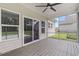 Screened-in porch with ceiling fan, wood floor, and backyard views at 1600 Palmetto Palm Dr., Myrtle Beach, SC 29579