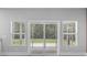 Sliding glass doors leading to a screened in porch area with natural lighting and wooded view at 1600 Palmetto Palm Dr., Myrtle Beach, SC 29579