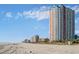 Beach view with people, palm trees, and hotels in the background at 1605 S Ocean Blvd. # 204, Myrtle Beach, SC 29577