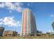 Beautiful high-rise condominium building on the beach with palm trees and blue skies at 1605 S Ocean Blvd. # 204, Myrtle Beach, SC 29577