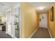 Hallway leads to a unit's entrance door, featuring neutral walls and carpet with closet at 1605 S Ocean Blvd. # 204, Myrtle Beach, SC 29577