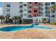 Outdoor pool with a swimmer and lounge chairs near the building at 1605 S Ocean Blvd. # 204, Myrtle Beach, SC 29577