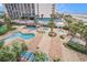 Aerial view of the pools surrounded by palm trees and lounge chairs at 1605 S Ocean Blvd. # 204, Myrtle Beach, SC 29577