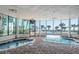 Indoor pool with palm trees viewed through glass walls at 1605 S Ocean Blvd. # 204, Myrtle Beach, SC 29577