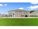 The backyard features a cozy seating area, outdoor grill, and lush green lawn at 171 Cassina Dr., Longs, SC 29568