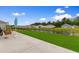 Relaxing backyard features a pond view, a swing, a patio, and lush green grass at 171 Cassina Dr., Longs, SC 29568