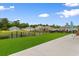 Backyard features an artificial lawn, pond, and an outdoor dining area at 171 Cassina Dr., Longs, SC 29568