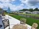 Backyard features an artificial lawn, pond, and an outdoor dining area at 171 Cassina Dr., Longs, SC 29568