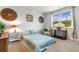 Bright bedroom featuring a comfortable bed, chair, and a large window offering natural light at 171 Cassina Dr., Longs, SC 29568