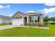 Inviting single-story home featuring a manicured lawn, neutral siding, and a two-car garage at 171 Cassina Dr., Longs, SC 29568