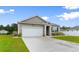 Well-maintained home showcasing a large driveway, charming siding, and an attached two-car garage at 171 Cassina Dr., Longs, SC 29568