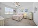 Bedroom featuring a window, comfortable bed, ceiling fan, and ample natural light at 1723 Perthshire Loop, Myrtle Beach, SC 29579