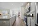 Open kitchen with stainless steel appliances, granite countertops, and a view into the dining and living area at 1723 Perthshire Loop, Myrtle Beach, SC 29579