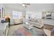 Bright living room with a modern ceiling fan, colorful rug, and comfortable furniture at 1723 Perthshire Loop, Myrtle Beach, SC 29579