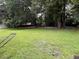An expansive backyard with shady trees, grass, and a swing set at 1903 Rose St., Conway, SC 29527