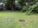 Large backyard with mature trees, green grass and partial drainage at 1903 Rose St., Conway, SC 29527