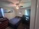 Small bedroom with a ceiling fan, a single bed, a desk with computer monitors, and dark curtains at 1903 Rose St., Conway, SC 29527