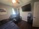 Bedroom with a large wall-mounted TV, dark curtains, and a black desk and chair at 1903 Rose St., Conway, SC 29527