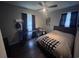 Cozy bedroom featuring neutral tones, a ceiling fan, dark curtains, and a large platform bed at 1903 Rose St., Conway, SC 29527