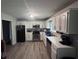 Well-lit kitchen features stainless steel appliances, white cabinetry, and wood-look flooring at 1903 Rose St., Conway, SC 29527