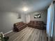 A living room with two brown couches, art on the walls, gray walls, and light wood-look flooring at 1903 Rose St., Conway, SC 29527
