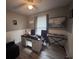 A home office with a desk, keyboard, two purple chairs, and light wood-look flooring at 1903 Rose St., Conway, SC 29527