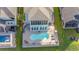 Aerial view of a home's private pool and outdoor living space backing onto lush green landscaping at 201 West Isle Of Palms Ave., Myrtle Beach, SC 29579