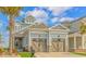 Charming exterior with a two car garage, stone accents, and a well manicured yard with mature landscaping at 201 West Isle Of Palms Ave., Myrtle Beach, SC 29579