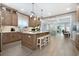 Open-concept kitchen with an island, seating, stainless appliances, and an adjacent dining and living area at 201 West Isle Of Palms Ave., Myrtle Beach, SC 29579