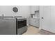 Modern laundry room equipped with washer, dryer, sink, and ample storage cabinets at 201 West Isle Of Palms Ave., Myrtle Beach, SC 29579