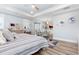 Bedroom features a serene color palette, tray ceiling, and a cozy seating area with a balcony at 201 West Isle Of Palms Ave., Myrtle Beach, SC 29579