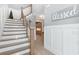 Inviting foyer with wooden stairs, white risers, and an adjacent wall adorned with decorative wood trim at 201 West Isle Of Palms Ave., Myrtle Beach, SC 29579