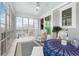 Bright sunroom with many windows and a ceiling fan, complete with sitting area and table at 201 West Isle Of Palms Ave., Myrtle Beach, SC 29579