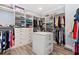 Large walk-in closet with custom shelving and storage, drawers, and hardwood floors at 201 West Isle Of Palms Ave., Myrtle Beach, SC 29579