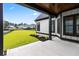 View of the back porch with black trim, a concrete pad, and a grassy yard at 2205 Yellow Morel Way, Myrtle Beach, SC 29579