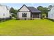 Exterior view of the home's backyard with a well-maintained lawn and modern design at 2205 Yellow Morel Way, Myrtle Beach, SC 29579