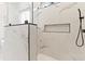 Elegant walk-in shower with marble tile, a rainfall shower head, and a niche for toiletries at 2205 Yellow Morel Way, Myrtle Beach, SC 29579