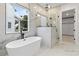 Spa-like bathroom featuring a freestanding tub and a glass-enclosed shower with black hardware at 2205 Yellow Morel Way, Myrtle Beach, SC 29579