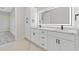Bathroom with double vanity, modern fixtures, an illuminated mirror and white marble countertops at 2205 Yellow Morel Way, Myrtle Beach, SC 29579